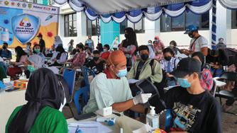 Cover for Indofood’s solidarity for humanity vaccinations Indofood provides homes with love