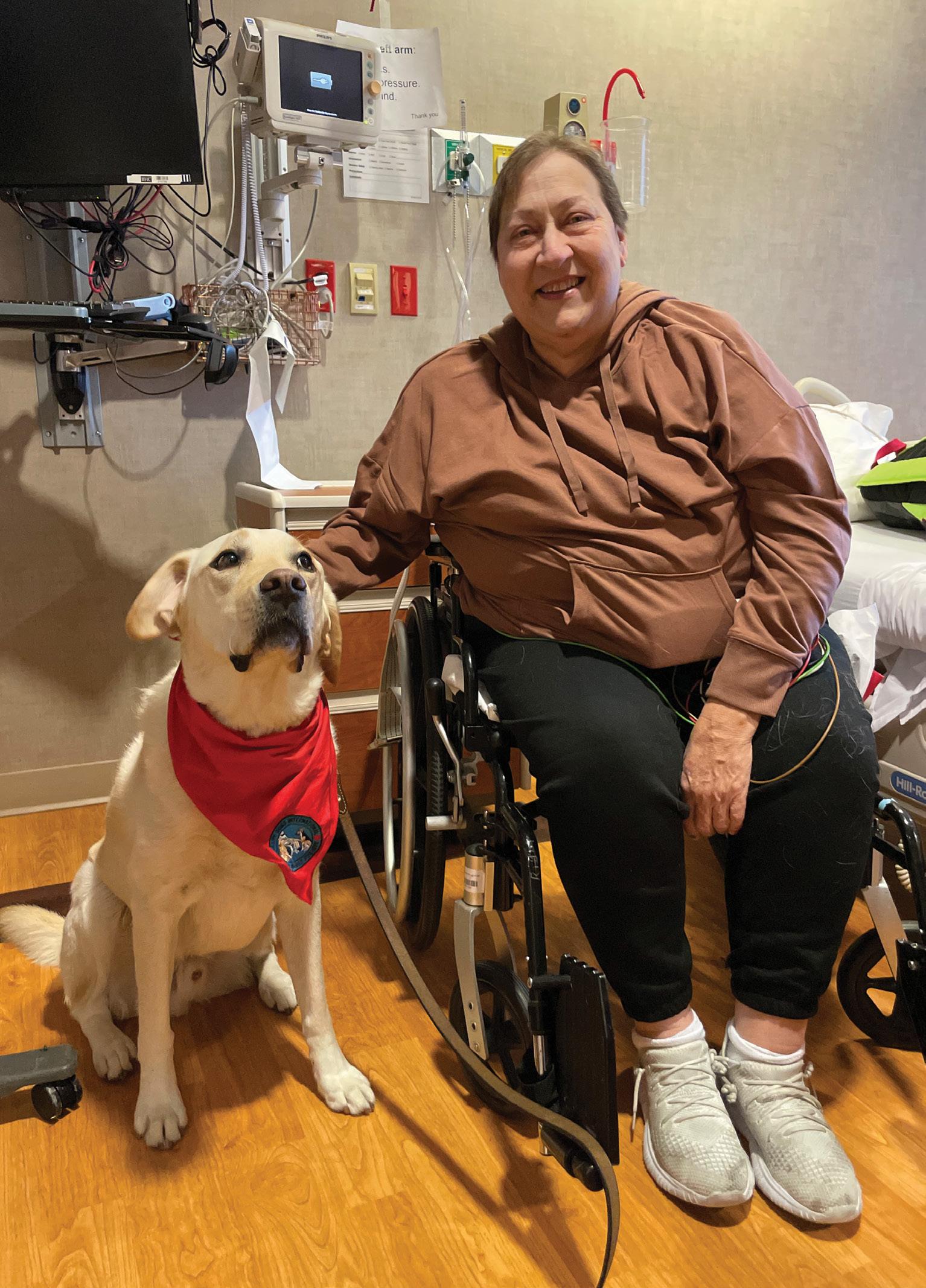 Timbre visiting with patient Dori Neumeier on the therapy floor.