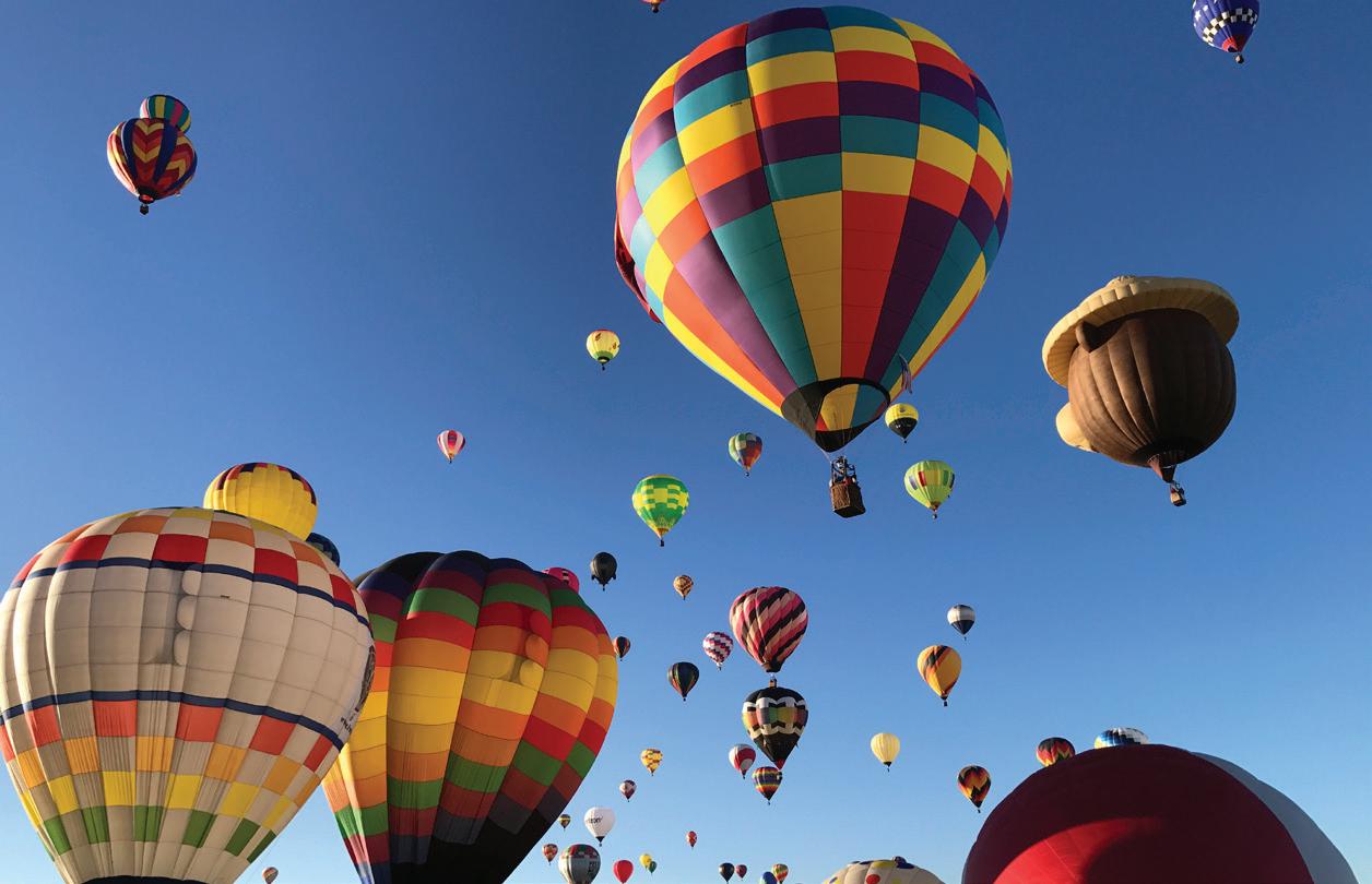 Colorful hot air balloons soaring at the 2025 Albuquerque Balloon Festival