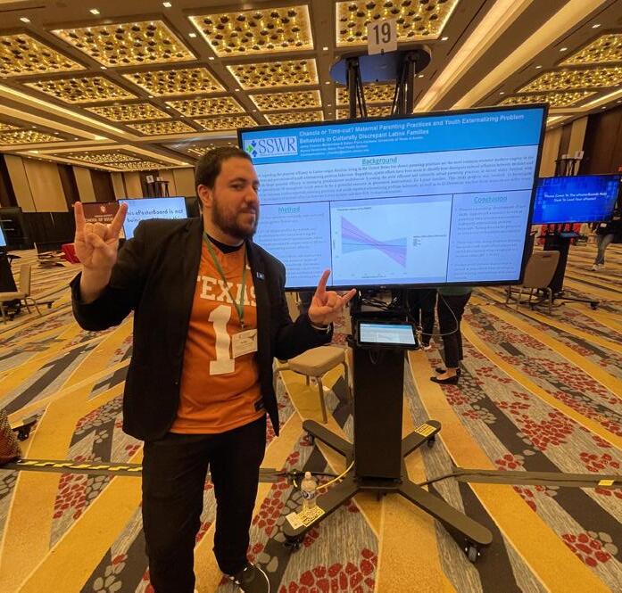 Fuentes Balderrama, dressed in his signature football jersey, presents a research poster at the SSWR annual conference.Jaime Fuentes Balderrama, left, holds a ceremonial mace ahead of UT's commencement ceremony.