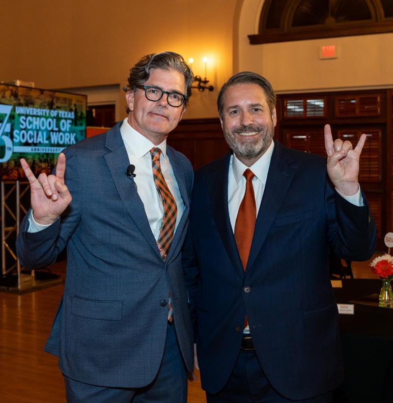 UT Austin president Jim Davis flashes a Hook 'Em with Dean Allan Cole at the State of the School address.