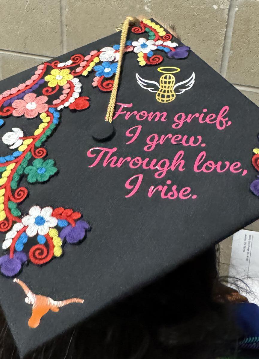 Medeiros honored her child Daniel "Peanut" Pressley on her graduation cap, a testament to her journey as a pediatric hospice worker.